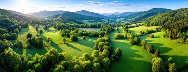 Aerial View Of Green Valley With Trees And Mountains Under Blue Sky Scenic Landscape For Travel And Tourism Summer Scenery Outdoor