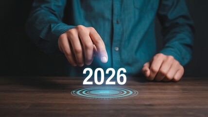 A person in a blue shirt interacting with a futuristic interface displaying the year 2026