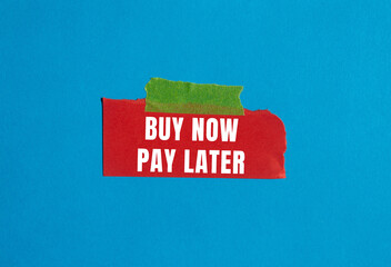 Buy now pay later message written on ripped torn paper background. Conceptual Buy now pay later...