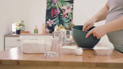 hands kneading dough on wooden surface with flour. Homemade baking process in kitchen. Traditional cooking technique for making fresh bread or pastry from scratch. Chef Baking Recipe. Cooking Routine.