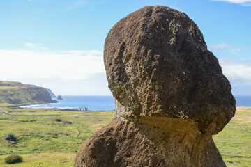 Moai statue overlooking landscape and ocean on Easter Island