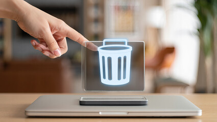 Digital Deletion Concept Featuring a Holographic Trash Can Icon Above a Laptop on a Wooden Surface Representing Data Management and Cybersecurity