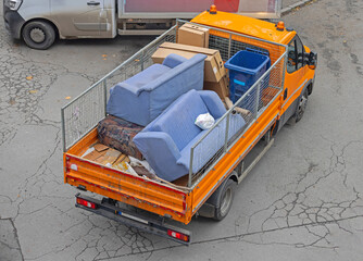Aerial View of Old Sofa Discard Furniture Removal Open Transport Truck at City Street