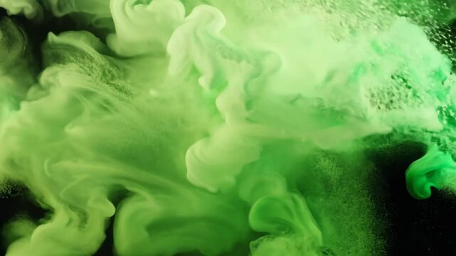 A dramatic explosion of vibrant green smoke fills the frame, set against a dark background. the plumes create intricate patterns, offering a striking visual for creative designs, digital art, and spec