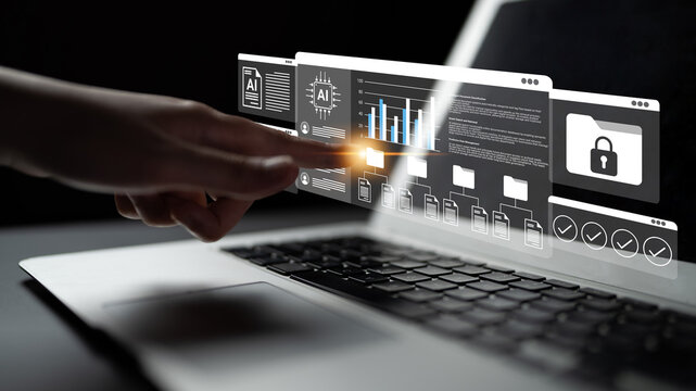 A user interacts with a futuristic digital interface featuring graphs and security elements on a laptop, showcasing advanced technology and innovative design in a modern workspace. Gantry - Powered by Adobe