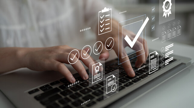 A close-up view of hands typing on a laptop keyboard surrounded by digital icons and checkmarks, symbolizing productivity and successful task management in a contemporary office. Gantry