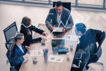 A dynamic business team engages in collaborative discussions surrounded by financial data graphs in a modern conference room, emphasizing teamwork and strategy. Scalp
