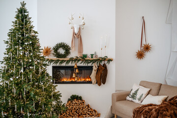 Cozy Christmas living room with decorated fireplace, tree, stockings, and warm sofa ambience