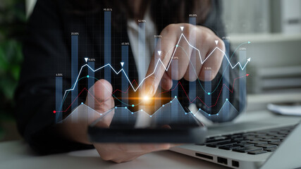 Modern office setting featuring business analytics with graphs and charts displayed on smartphone and laptop, illustrating financial growth and data insights. Scalp