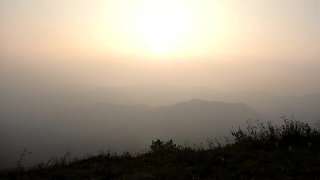 The panoramic landscape of Parunthumpara, Idukki, Kerala, India covered in heavy fog at dusk