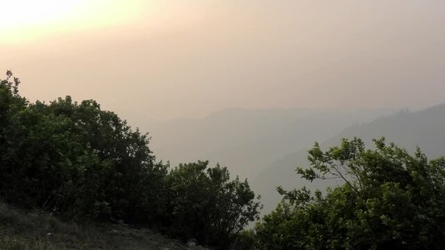 The panoramic landscape of Parunthumpara, Idukki, Kerala, India covered in heavy fog at dusk