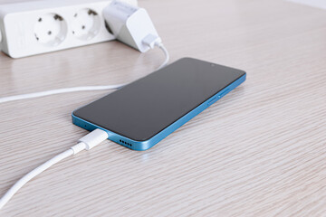 Smartphone charging with power strip and adapter.