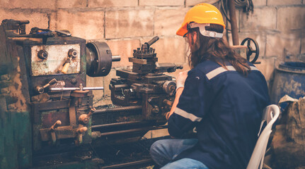 Portrait of Heavy industry workers working on the metal fabrication process by operating a lathe at a machine for steel structure industry.