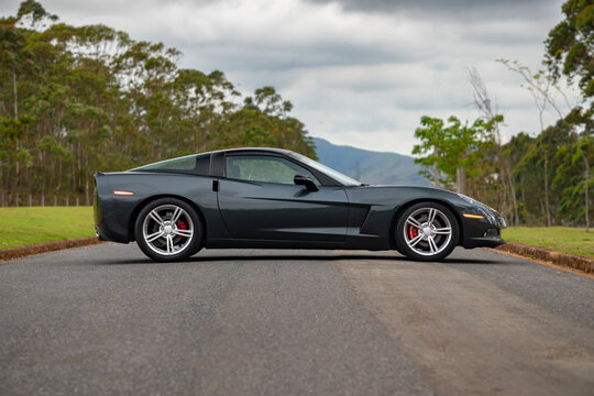 Gray Chevrolet Corvette C6 side profile view, American sports car coupe outdoors