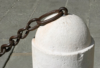 chain on ancient stone bollard