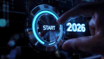 Start 2026: Hand pushing futuristic blue illuminated digital button on a dark technical dashboard, representing new beginnings, innovation, business planning, and technology goals.