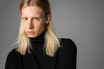 Obraz premium Stylish non binary individual exuding confidence in sleek black attire and timeless elegance