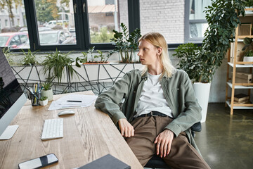 Stylish non binary person enjoying a moment of reflection in a modern workspace