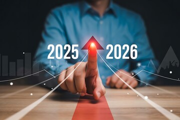 Businessman pointing to a red arrow with 2025 and 2026 for growth and development