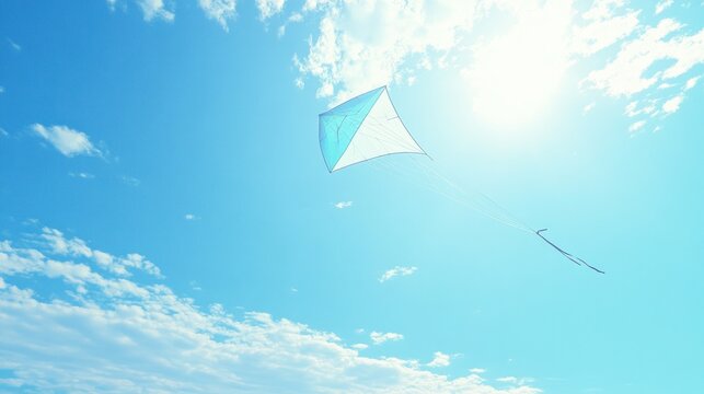 Blue diamond kite soaring in sunny sky with clouds