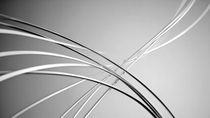 Abstract close-up of curved metallic wires crossing over a soft gray background. Concept Abstract metal wires, Curved lines, Close-up texture, Industrial aesthetic, Soft gray background