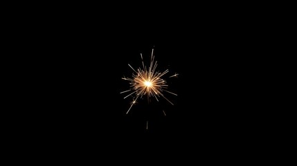 Obraz premium Single Golden Sparkler Explosion Bursting with Bright Sparks on a Dark Black Background for Celebration and Night Event