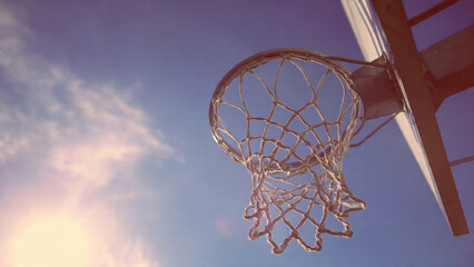 Basketball hoop against blue sky