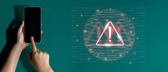 A person interacts with a smartphone while viewing a digital security alert, featuring a warning icon and binary code, emphasizing the importance of cybersecurity awareness. Gantry