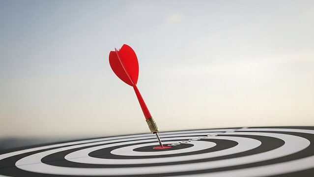 Dart hitting bullseye on target