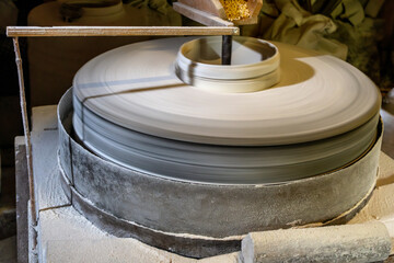 Inside the old wooden flour grinding mill. Interior of retro wooden watermill with old equipment for grinding or milling grain into flour © Ivan