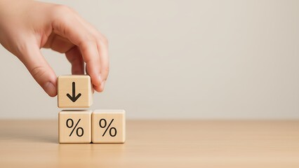 Hand placing a block with a downward arrow on top of blocks with percentage signs