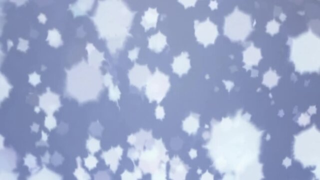 Snowflakes falling softly against a light blue winter background  