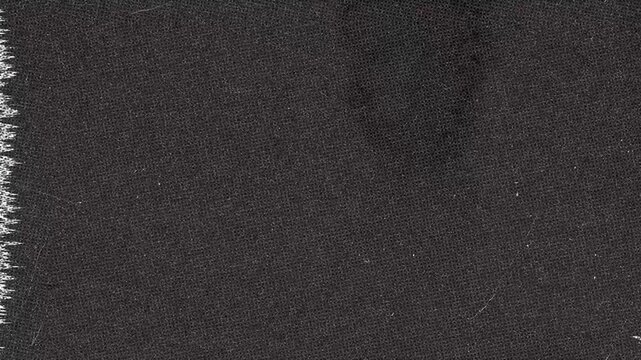 Close up look at dark textured Fabric with edge detail