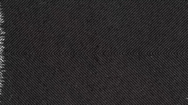 Close up of black fabric with herringbone weave pattern