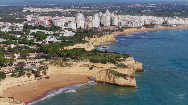 Algarve Luxury Real Estate: Panoramic 4K Aerial View of Premium Villas and Resorts in Arma&ccedil;&atilde;o de P&ecirc;ra Overlooking the Turquoise Coastline of Praia de Albandeira, Portugal