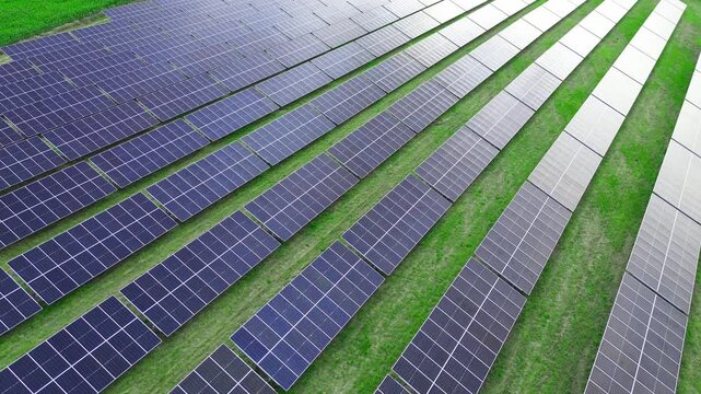Sunlit solar panels in open green field