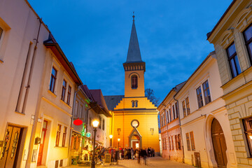 Illuminated Calvinist church built in 1811 during Christmas on famous Pottery street in the pedestrian part of Old Town, Kosice, Slovakia