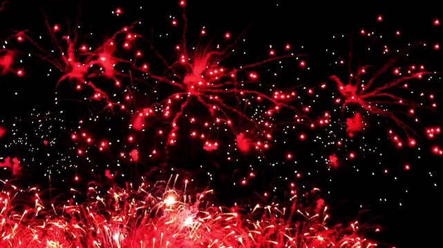 4K. loop seamless of real fireworks background golden shining fireworks with bokeh lights in the night sky. glowing fireworks show. New year's eve fireworks celebration multiple colors 