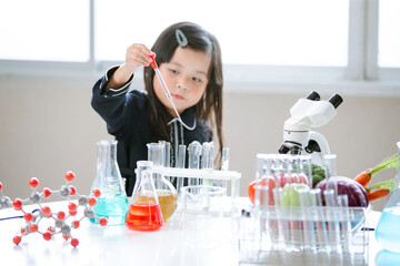 Asian little cute girl students. Girl doing science experiment science classroom. Education research and development concept learning kids.