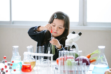 Asian little cute girl students. Girl doing science experiment science classroom. Education research and development concept learning kids.