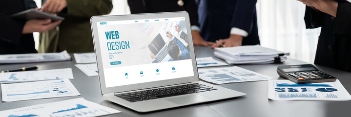 Panorama shot analyst team utilizing BI Fintech to analyze financial report with laptop. Businesspeople analyzing BI data dashboard displayed on laptop screen for business insight. Prodigy