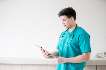 Portrait of adult man doctor stand with clipboard on the terrace