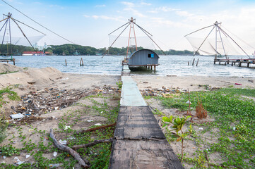 Chinese fishing nets with wooden jetty on the shore of Kochi, Kerala in India, Cheena vala or tangkul, traditional stationary lift net