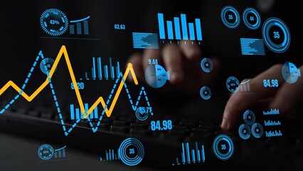 A close-up image depicts a hands-on keyboard interaction with digital graphs and charts, emphasizing modern data analysis in a high-tech office setting. Xenic