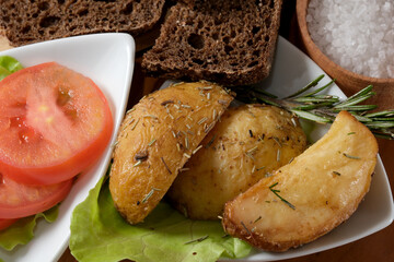 Crispy roasted potatoes with fresh herbs and vibrant tomatoes await