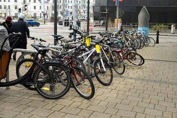 Double-decker bicycle parking with various bicycles in an urban environment