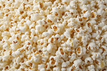 A close-up view of freshly popped popcorn fills the entire frame.
