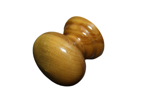 Two wooden knobs on a clean white surface