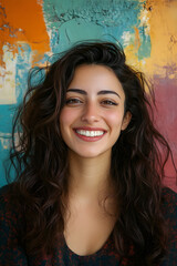 Joyful Middle-Eastern woman smiling against a colored background