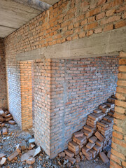 The interior of an unfinished cottage with brick walls